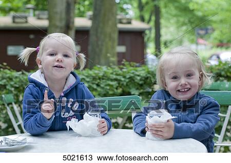 Stock Image - Two girls in park . Fotosearch