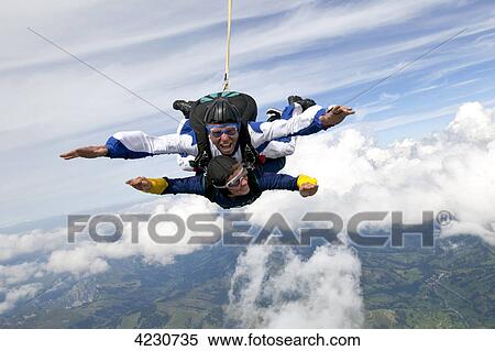 Two men doing parachute jumping, Saanen, Canton Bern, Switzerland View Large Photo Image Stock Photography - Two men doing parachute jumping, Saanen, Canton Bern, Switzerland . Fotosearch