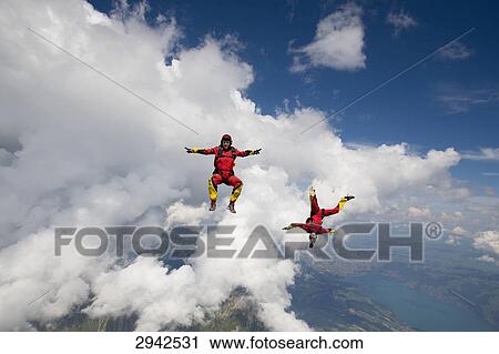 two people doing parachute jumping, full shot View Large Photo Image Stock Image - two people doing parachute jumping, full shot . Fotosearch