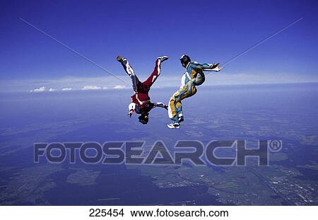 Picture - Two people parachuting mid air . Fotosearch