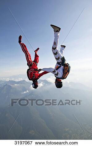 Stock Photo - Two skydivers falling in head-down position, Locarno, Tessin, Switzerland . Fotosearch