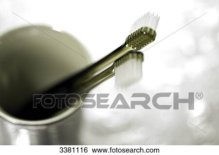 Stock Photograph - Two toothbrushes in toothbrush cup, close-up . Fotosearch