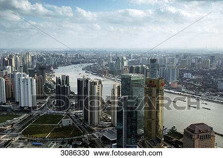 Stock Image - View from the Oriental Pearl Tower with the river Huangpu in the foreground, Shanghai, China . Fotosearch