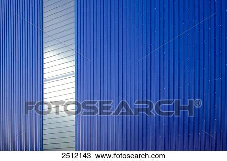 Stock Image - Windows on blue wall of storehouse . Fotosearch