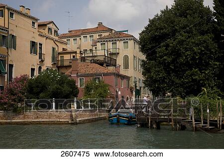 Stock Photography - Woman standing on bridge on canal, Grand Canal, Veneto, Venice, Italy . Fotosearch
