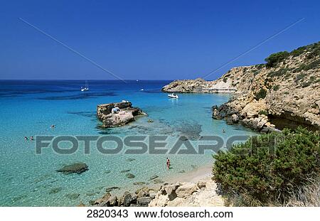 Aerial view of tourists in shallow water, Cala Tarida, Ibiza, Balearic Islands, Spain View Large Photo Image Stock Image - Aerial view of tourists in shallow water, Cala Tarida, Ibiza, Balearic Islands, Spain . Fotosearch