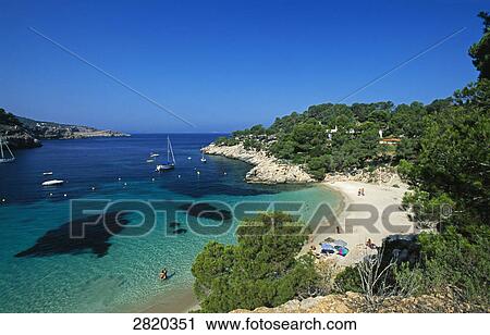 Aerial view of tourists on beach, Cala Salada, Ibiza, Balearic Islands, Spain View Large Photo Image Stock Image - Aerial view of tourists on beach, Cala Salada, Ibiza, Balearic Islands, Spain . Fotosearch