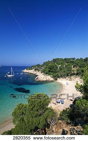 Stock Photography - Aerial view of tourists on beach, Cala Salada, Ibiza, Balearic Islands, Spain . Fotosearch