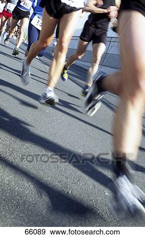 Stock Photo - Athletes running in marathon . Fotosearch