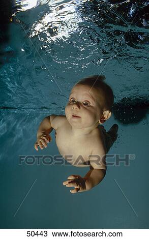 Baby boy swimming underwater View Large Photo Image Stock Image - Baby boy swimming underwater . Fotosearch