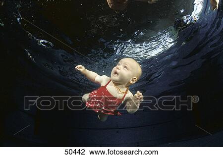 Baby girl swimming under water View Large Photo Image Stock Image - Baby girl swimming under water . Fotosearch