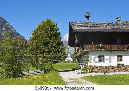 Stock Photo - Barnyard and church, Pertisau, Tyrol, Austria, Europe . Fotosearch