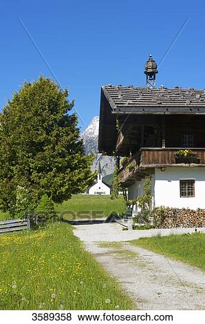 Stock Photo - Barnyard and church, Pertisau, Tyrol, Austria, Europe . Fotosearch