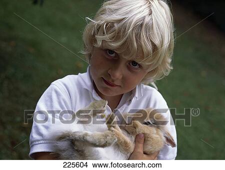 blonde boy with a bunny in his arms  View Large Photo Image Picture - blonde boy with a bunny in his arms . Fotosearch