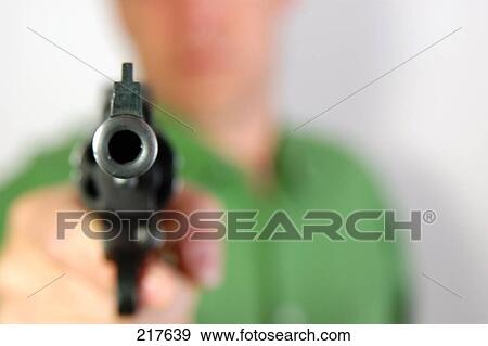 Stock Photo - Blurred view of man aiming with revolver . Fotosearch