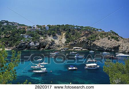Stock Photo - Boats in sea, Cala Vadella, Ibiza, Balearic Islands, Spain . Fotosearch