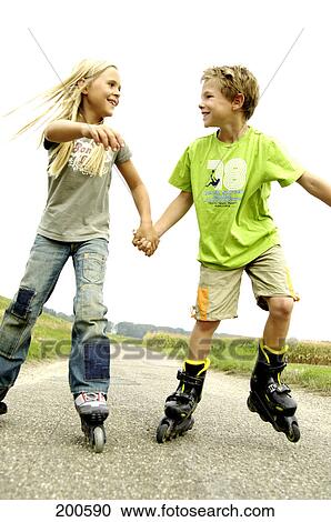 Stock Image - Boy and girl roller-skating . Fotosearch