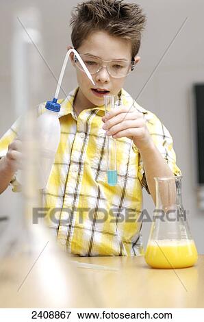 Stock Photo - Boy doing science experiments . Fotosearch