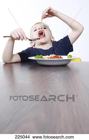 Boy eating pasta View Large Photo Image Picture - Boy eating pasta . Fotosearch