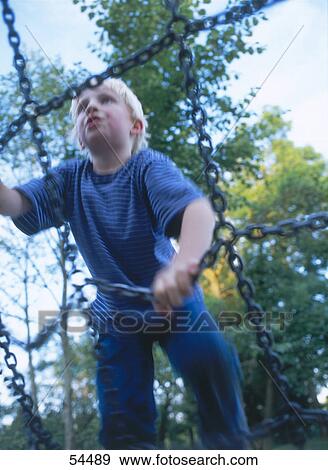 Boy playing in playground View Large Photo Image Stock Photo - Boy playing in playground . Fotosearch