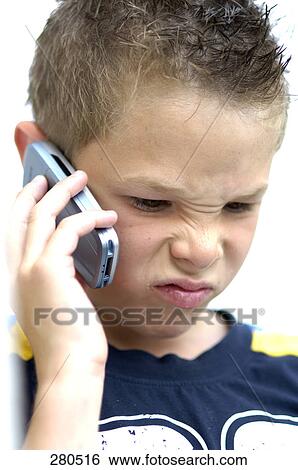 Stock Photograph - Boy using mobile phone . Fotosearch