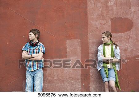 Boy with headphones and girl leaning at wall View Large Photo Image Stock Photograph - Boy with headphones and girl leaning at wall . Fotosearch