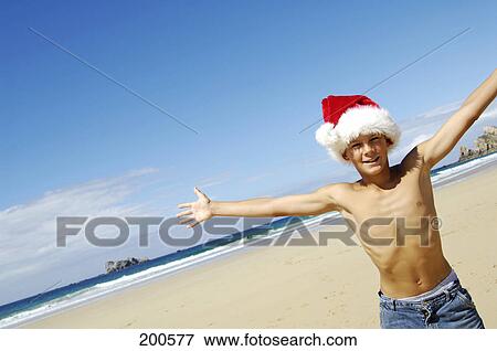 Stock Photo - Boys stretching his arms on beach . Fotosearch