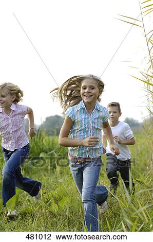 Brother and sisters running in field View Large Photo Image Stock Image - Brother and sisters running in field . Fotosearch