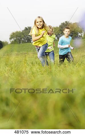 Brother and sisters running in field View Large Photo Image Stock Photography - Brother and sisters running in field . Fotosearch