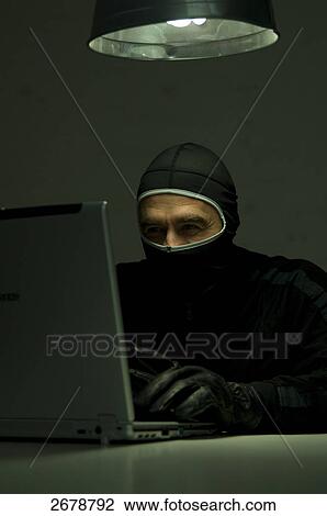 Burglar using laptop View Large Photo Image Stock Image - Burglar using laptop . Fotosearch