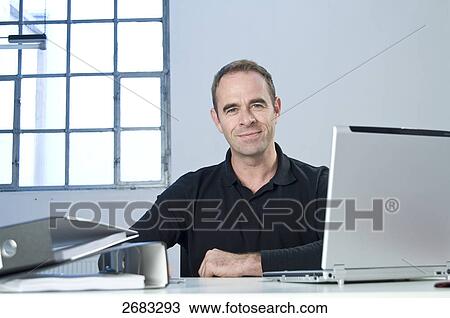 Stock Image - businessman and his notebook, portrait . Fotosearch