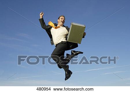 Picture - Businessman cheering in midair . Fotosearch