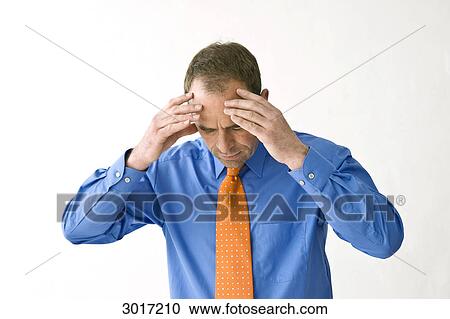 Businessman holding hands on his forehead View Large Photo Image Stock Image - Businessman holding hands on his forehead . Fotosearch