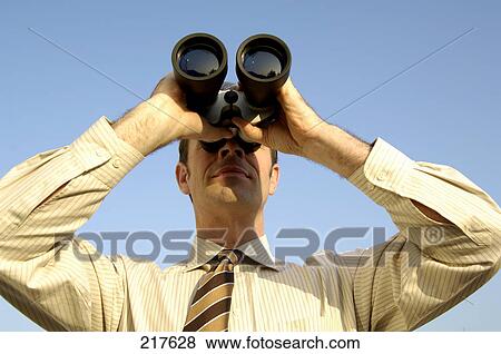 Businessman looking through binocular View Large Photo Image Stock Photo - Businessman looking through binocular . Fotosearch