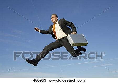 Businessman running in midair View Large Photo Image Stock Image - Businessman running in midair . Fotosearch