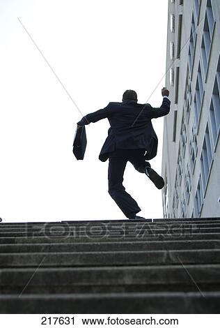 Businessman running upstairs, rear view View Large Photo Image Stock Image - Businessman running upstairs, rear view . Fotosearch