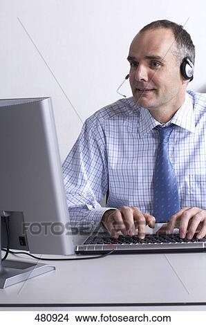 Picture - Businessman working on computer . Fotosearch
