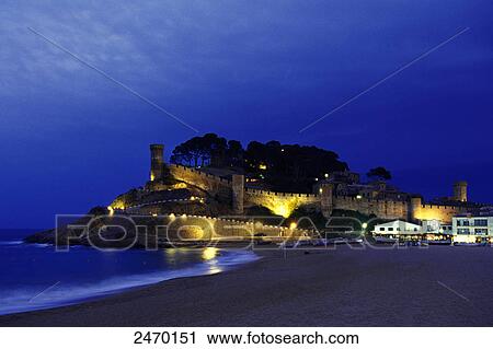 Stock Image - Castle lit up on coast, Vila Vella, Tossa de Mar, Costa Brava, Catalonia, Spain . Fotosearch