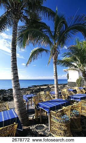 Chairs and tables at beach bar, Puerto Del Carmen, Lanzarote, Canary Islands, Spain View Large Photo Image Stock Image - Chairs and tables at beach bar, Puerto Del Carmen, Lanzarote, Canary Islands, Spain . Fotosearch