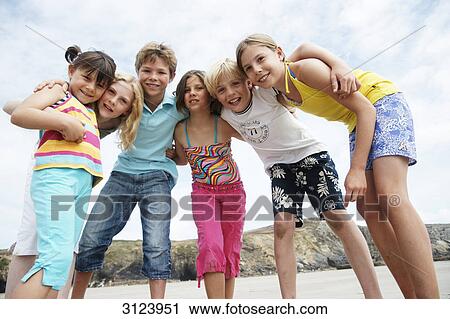 Stock Image - Children on the beach, low angle view . Fotosearch