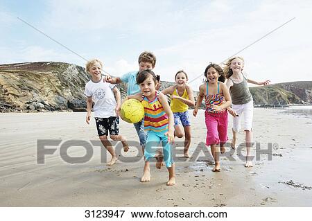 Children running on the beach View Large Photo Image Stock Photo - Children running on the beach . Fotosearch