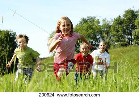 Children running over meadow View Large Photo Image Picture - Children running over meadow . Fotosearch