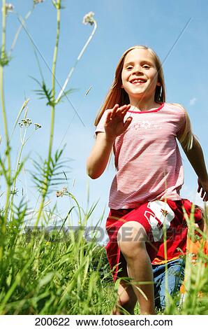 Children running over meadow View Large Photo Image Stock Image - Children running over meadow . Fotosearch