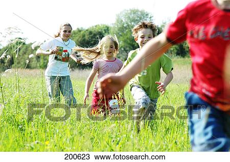 Children running over meadow View Large Photo Image Stock Image - Children running over meadow . Fotosearch