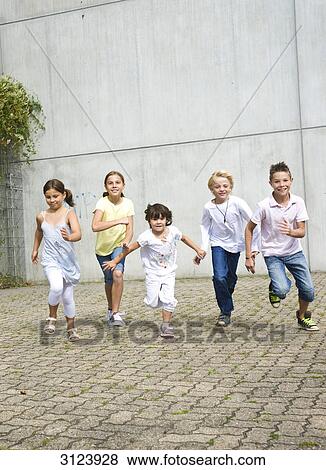 Stock Photo - Children running towards camera, front view . Fotosearch