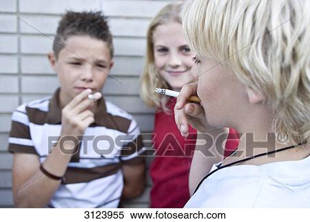 Children smoking cigarettes, close-up View Large Photo Image Stock Photography - Children smoking cigarettes, close-up . Fotosearch