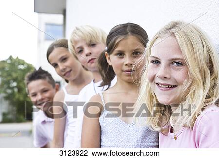 Children standing in a row, front view View Large Photo Image Stock Image - Children standing in a row, front view . Fotosearch