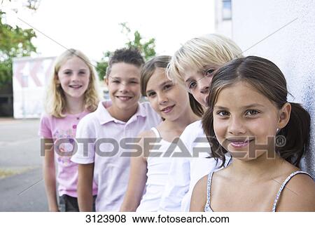 Stock Photo - Children standing in a row, front view . Fotosearch