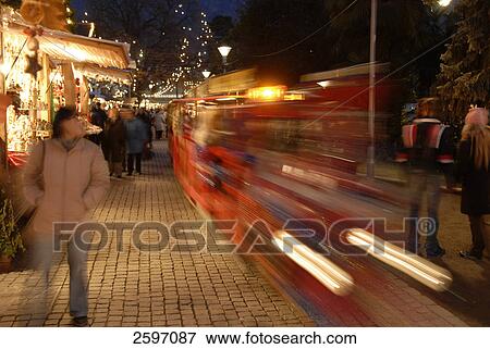 Stock Photo - Children train in motion at Christmas fair, Trentino-Alto Adige, Italy . Fotosearch