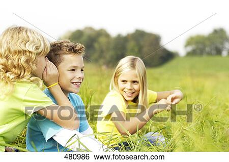 Stock Photograph - Children wispering . Fotosearch